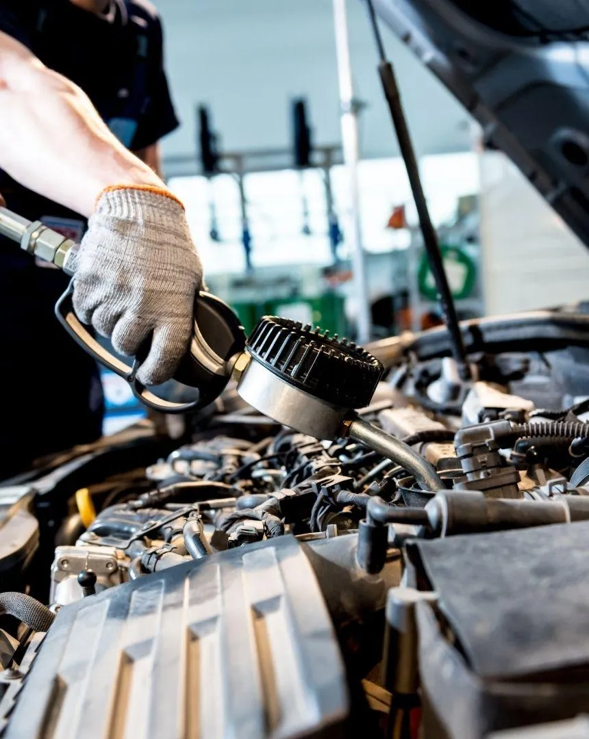Mechanic holding wrenches for routine maintenance