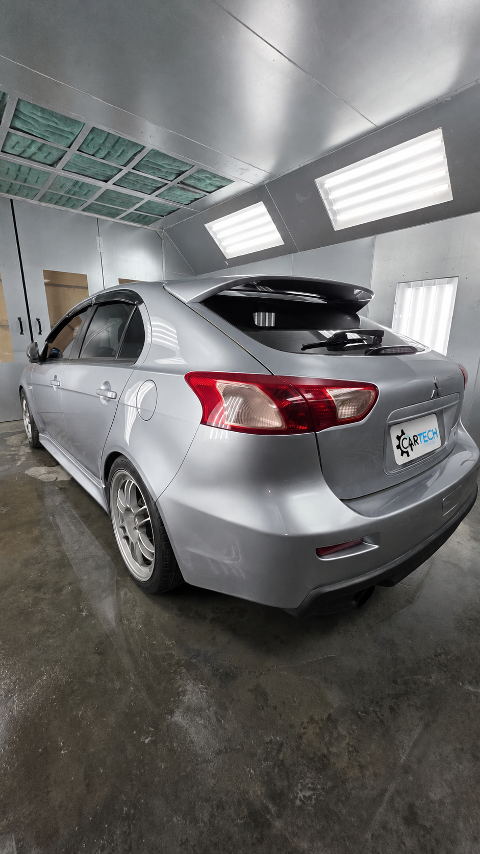 Silver Mitsubishi after paint in CarTech's booth in Smyrna, TN