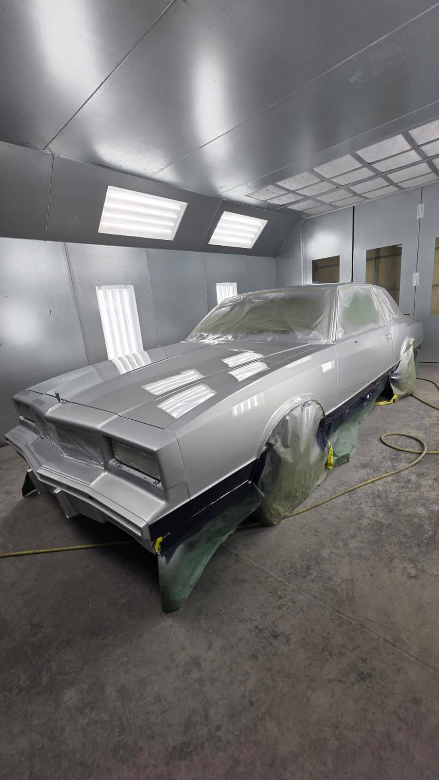 Silver classic car side view in booth — CarTech Automotive Smyrna TN