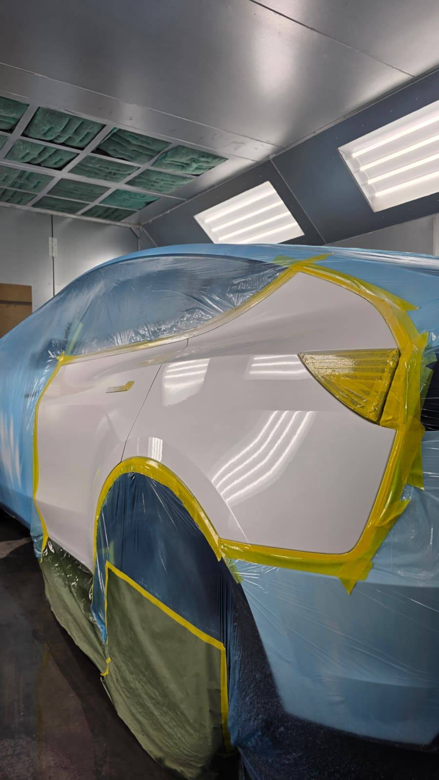 White panel with blue wrap masked for spot repair