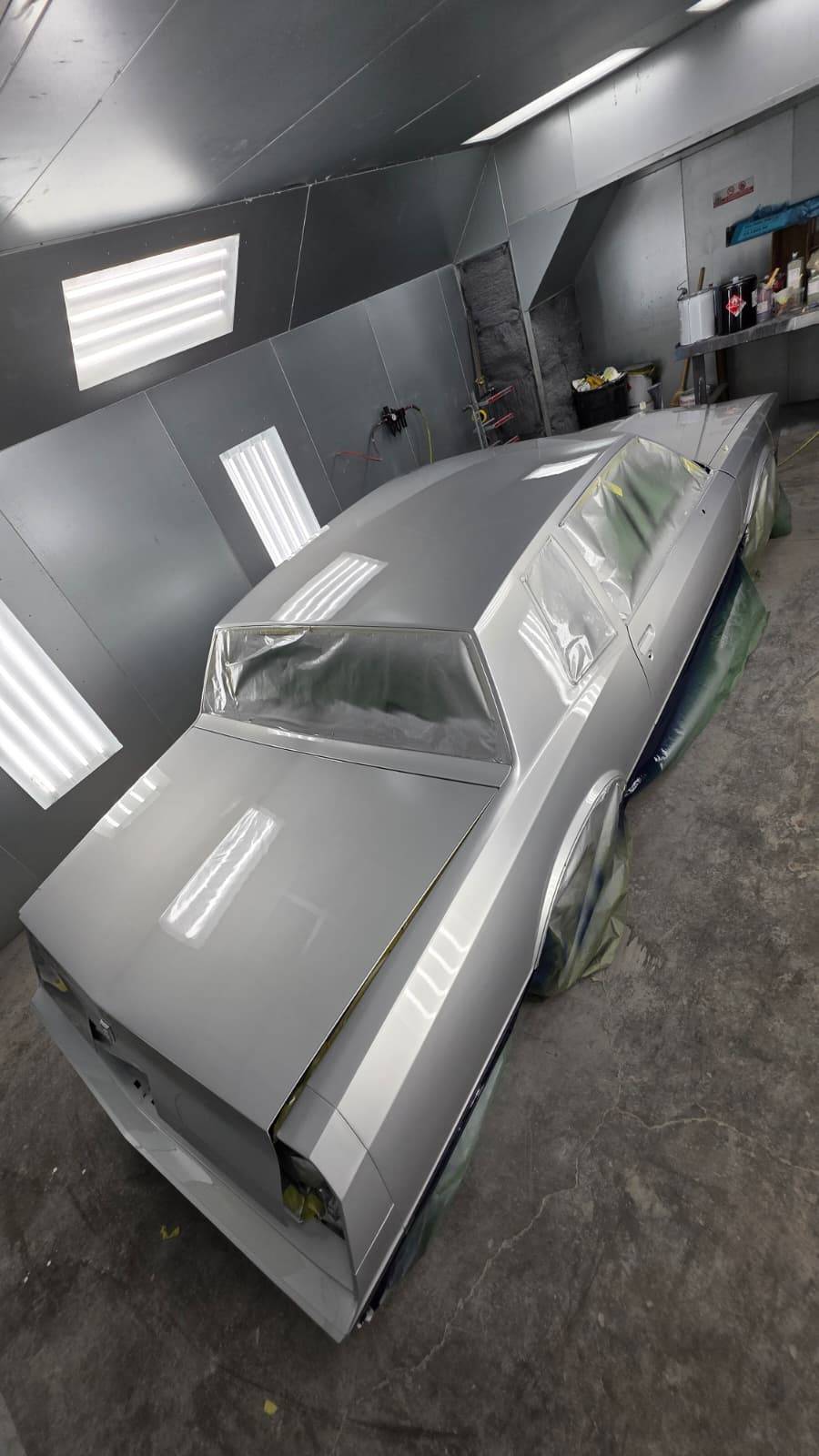Classic car rear quarter panel in paint booth